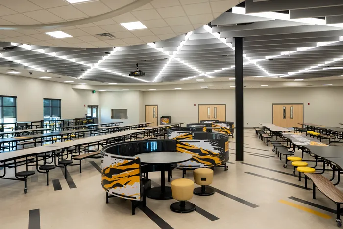 Clean and modern cafeteria at Hernando High School with polished floors, tables, and bright lighting.