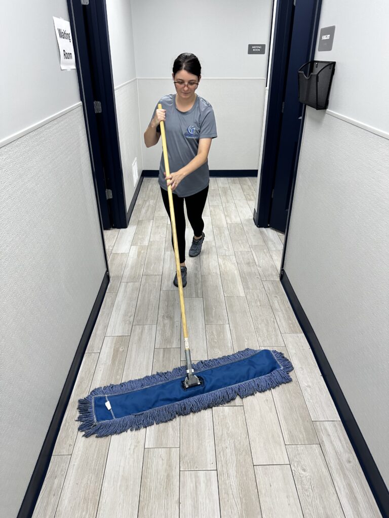 Midsouth Cleaning staff mopping office hallway as part of routine janitorial service.
